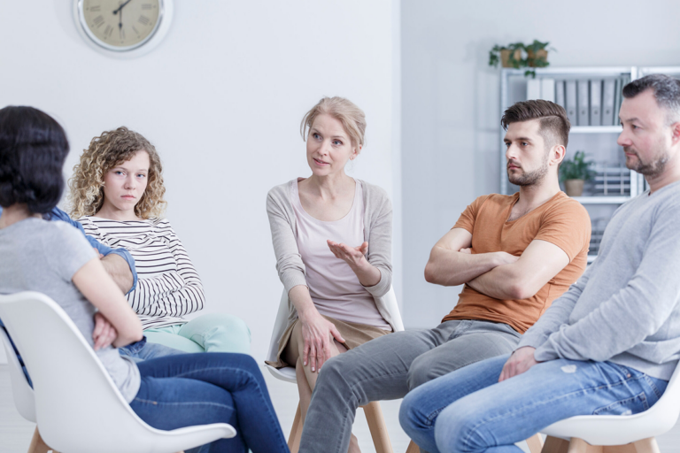 A family of 5, sitting in deep discussion
